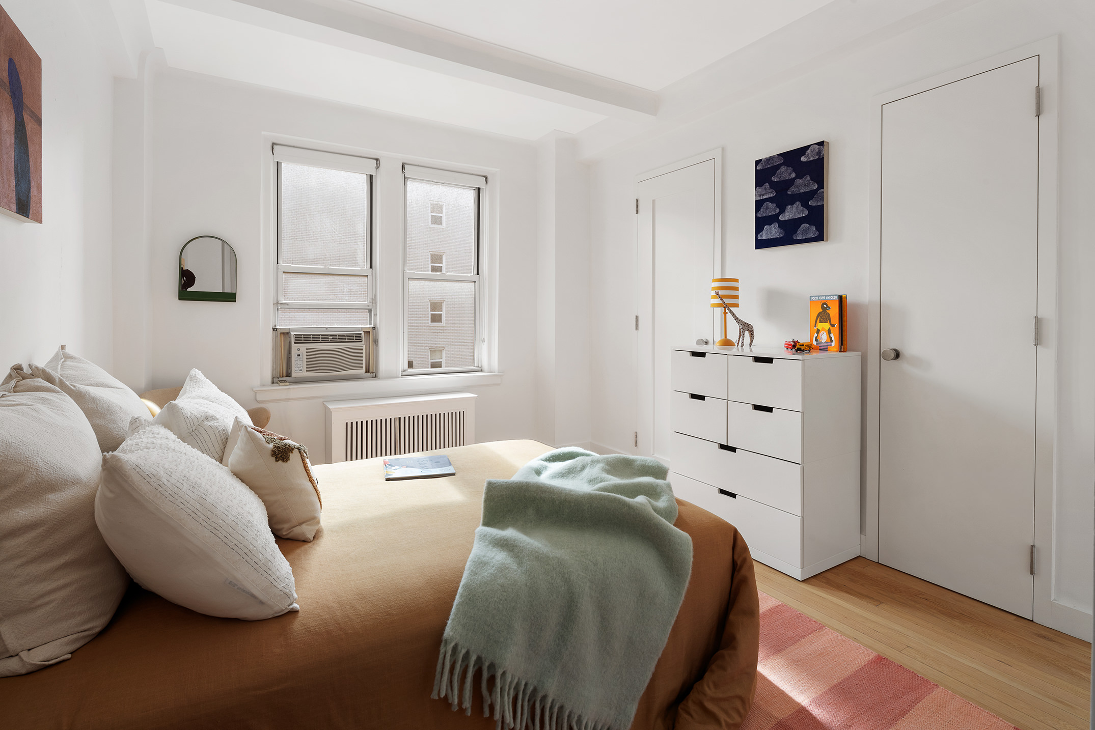 425 East 86th Street, Unit 11E Manhattan, NY 10028 - Photo 12 of 19 a bedroom with a bed and a window