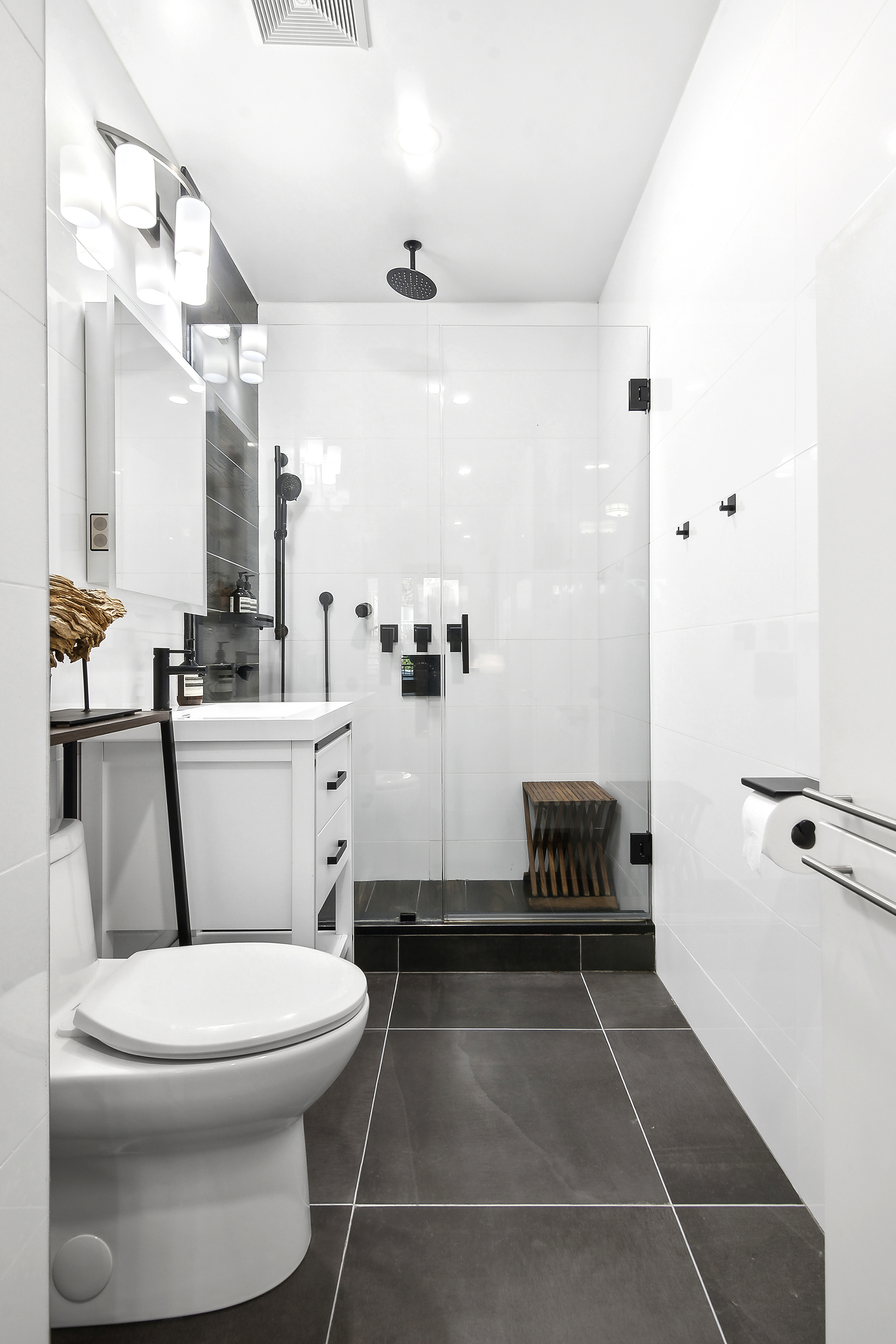 1043 Halsey Street, Unit 1 Brooklyn, NY 11207 - Photo 10 of 14 a bathroom with a toilet a sink and a mirror