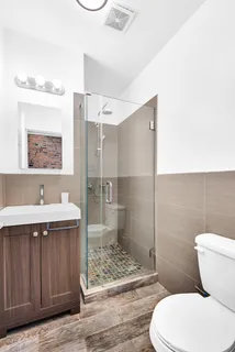 a bathroom with a toilet sink and shower