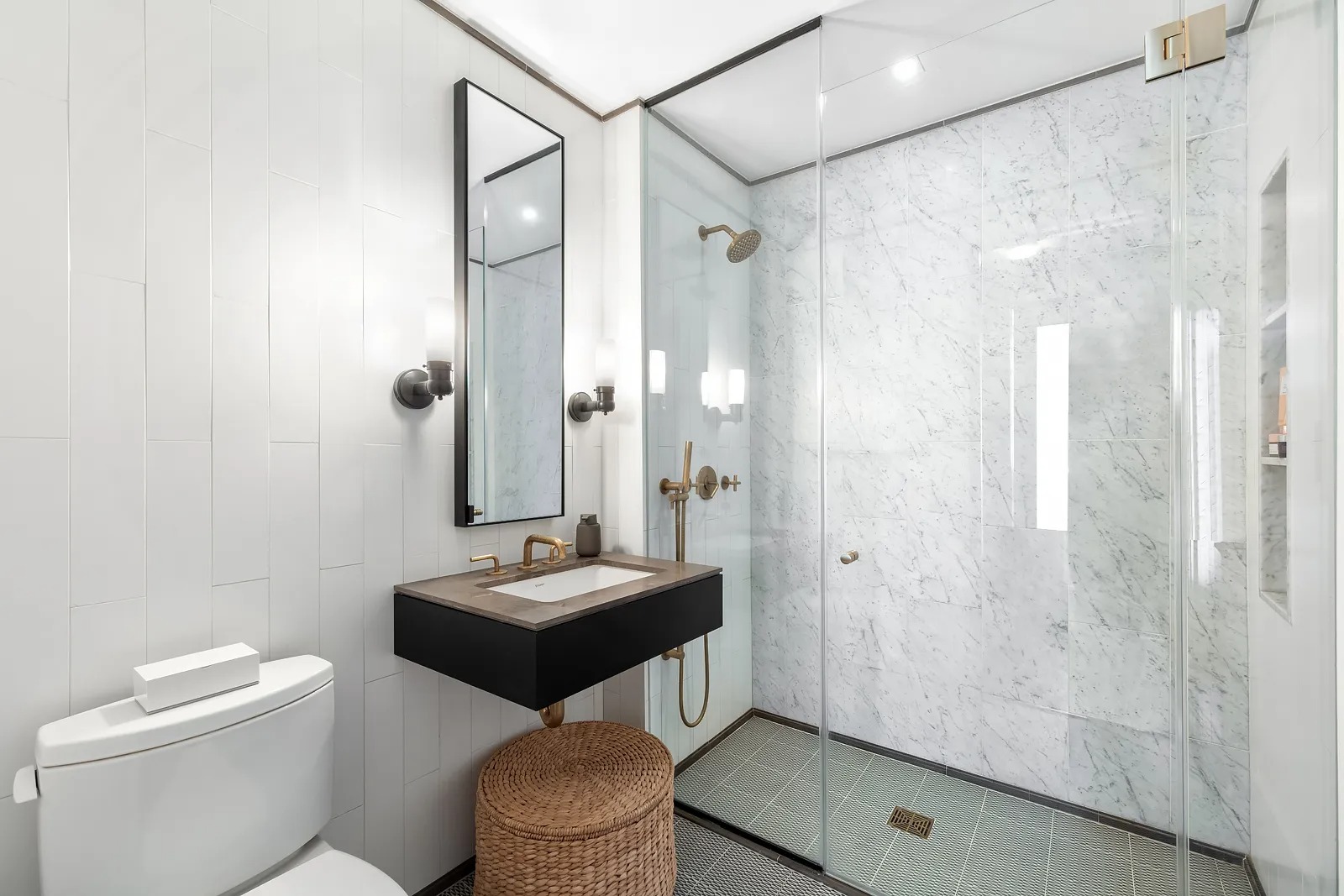 50 Clinton Street, Unit 2B Manhattan, NY 10002 - Photo 6 of 11 a bathroom with a sink a toilet and shower