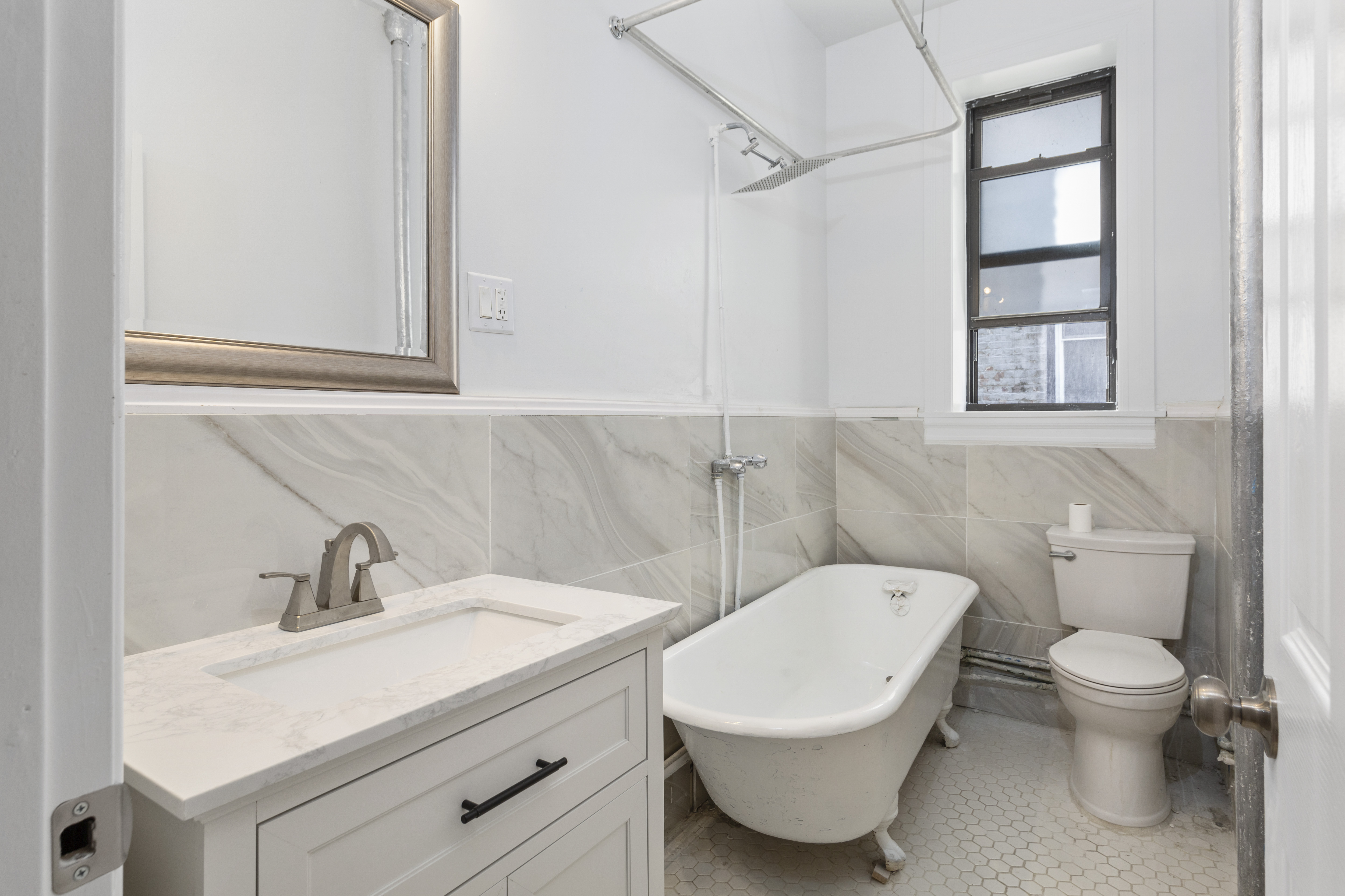 172 Prospect Park West, Unit 3L Brooklyn, NY 11215 - Photo 7 of 10 a bathroom with a toilet a sink and mirror