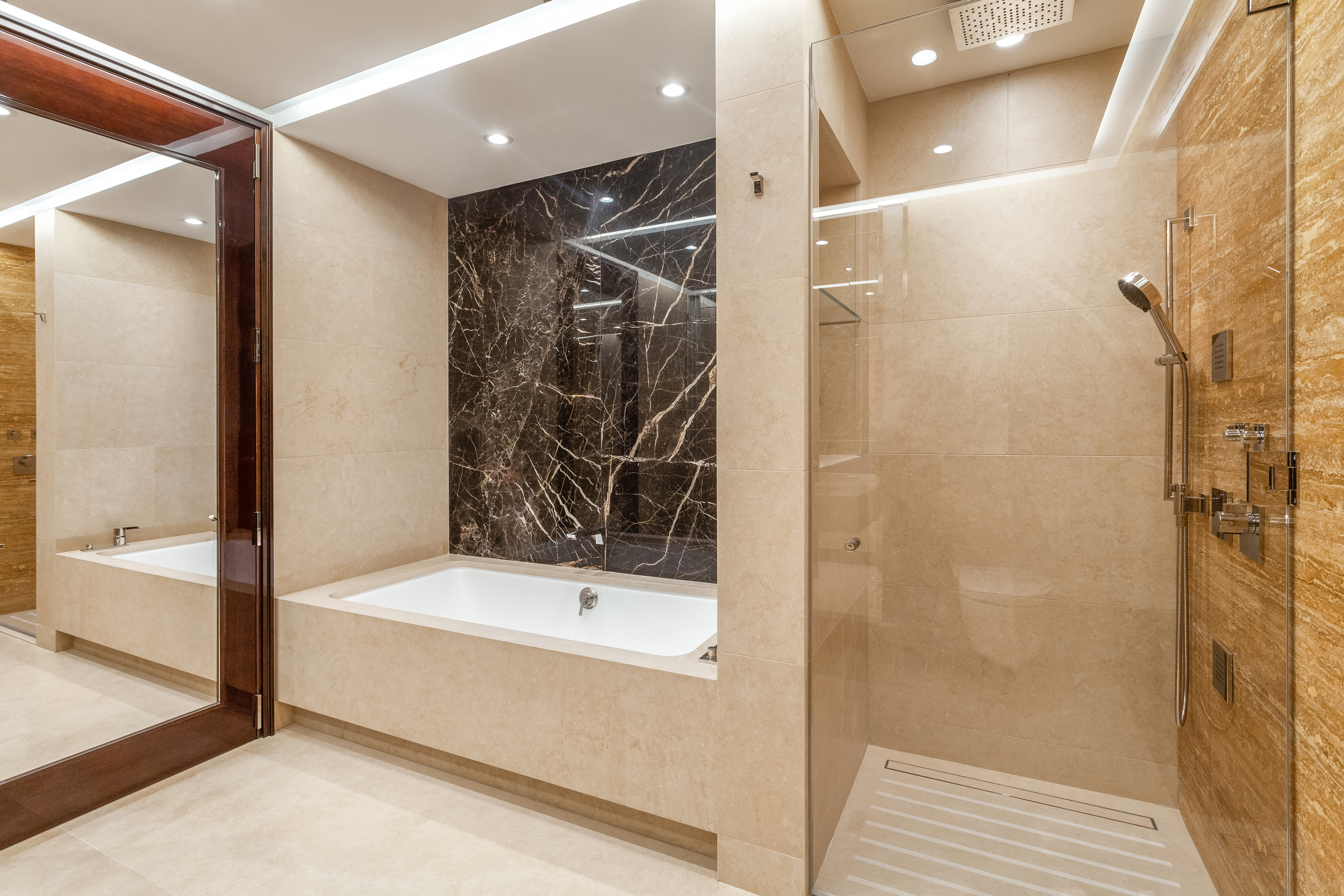 53 West 53rd Street, Unit 16C Manhattan, NY 10019 - Photo 8 of 12 a bathroom with a bathtub and a shower