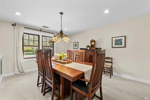 a kitchen with granite countertop a sink a counter top space and living room view