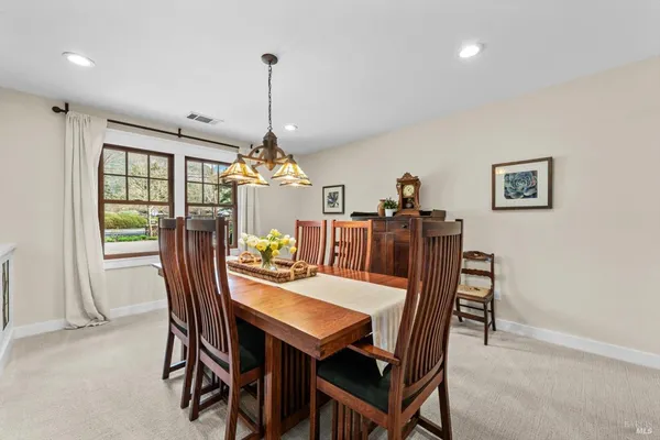 a kitchen with granite countertop a sink a counter top space and living room view