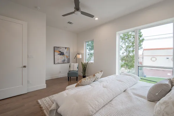 a bedroom with a bed and a chandelier