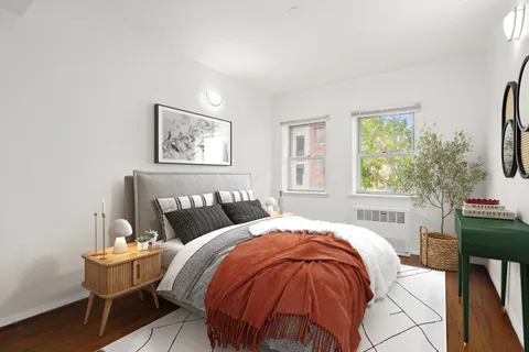 a bedroom with a bed and a table