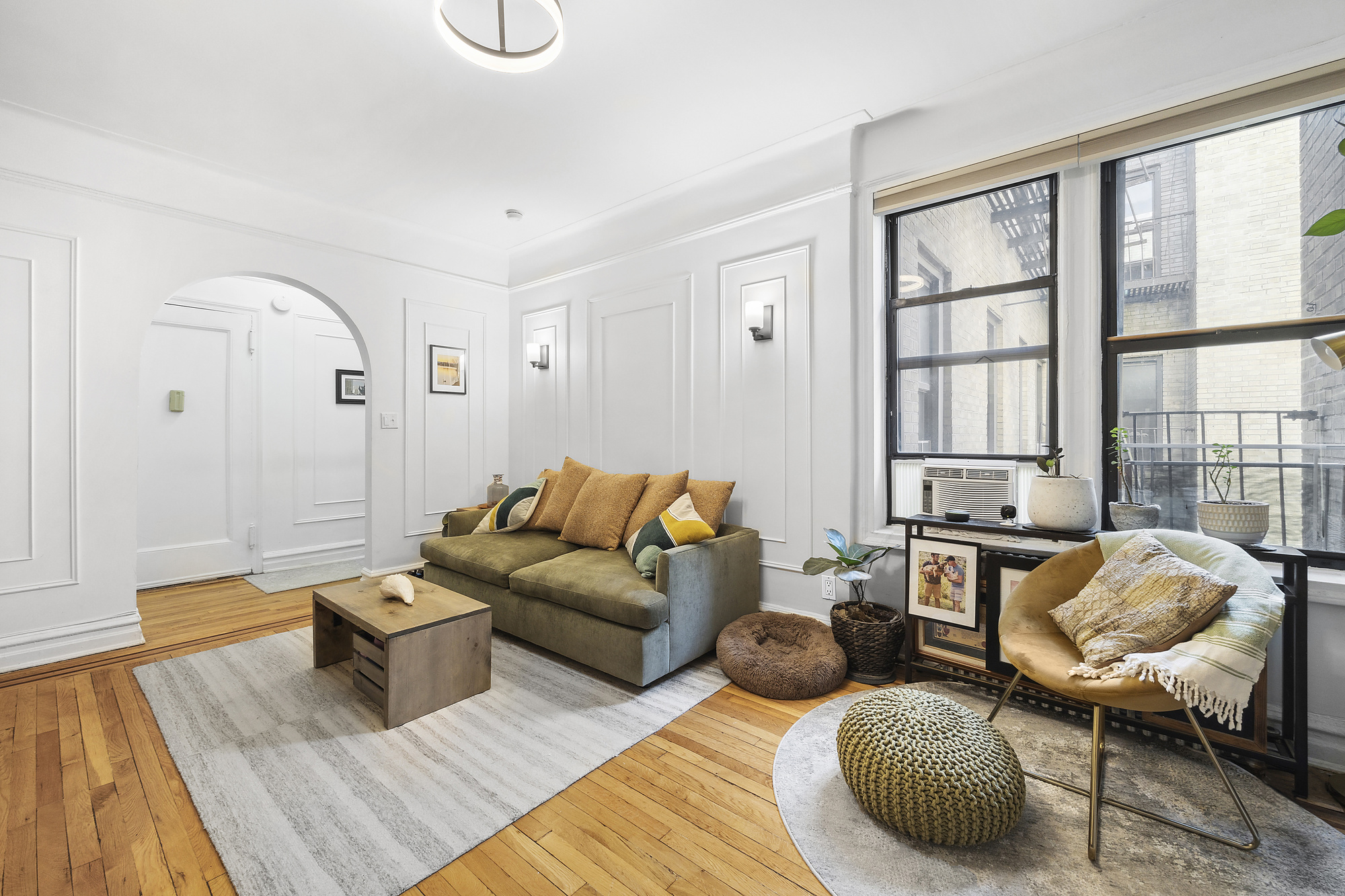225 Bennett Avenue, Unit 5H Manhattan, NY 10040 - Photo 2 of 10 a living room with furniture rug and wooden floor