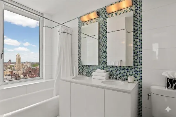 a bathroom with a granite countertop sink and a bathtub