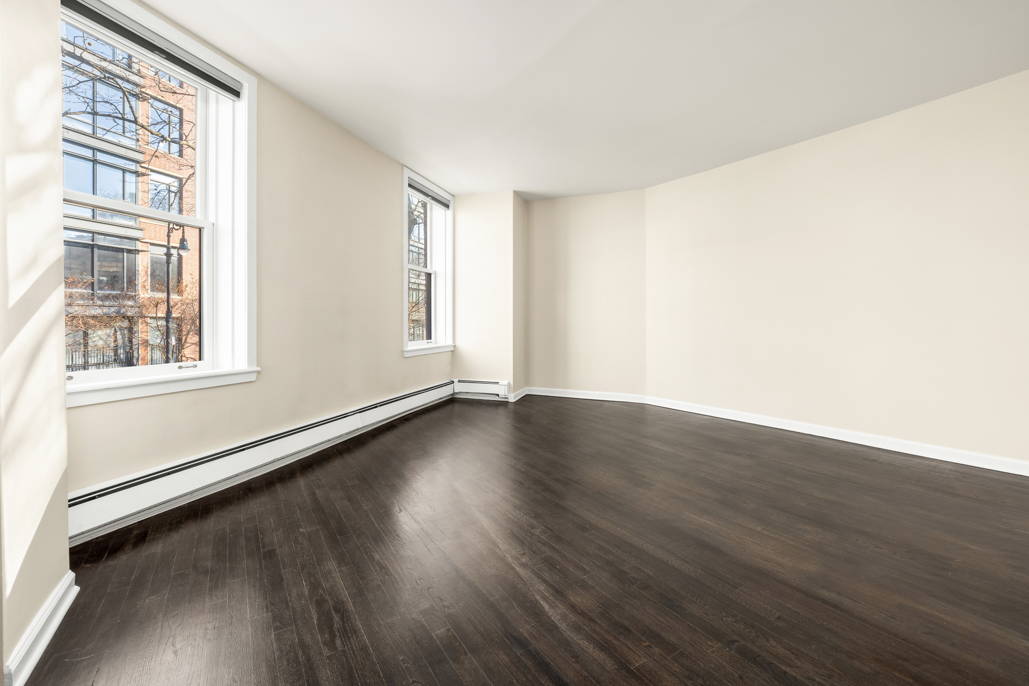 160 West 11th Street, Unit 1 Manhattan, NY 10011 - Photo 10 of 18 an empty room with wooden floor and windows