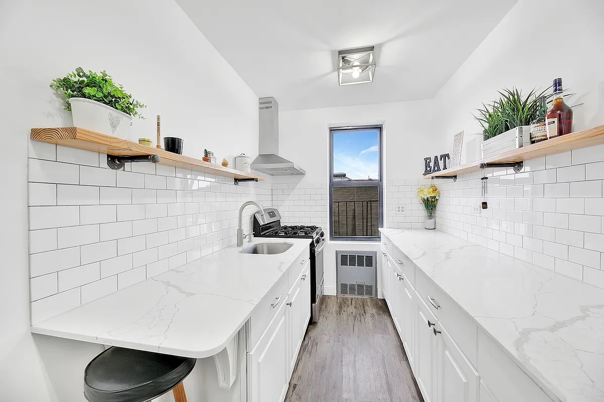 9040 Fort Hamilton Parkway, Unit 4G Brooklyn, NY 11209 - Photo 5 of 12 a spacious bathroom with a double vanity sink a potted plant and a bathtub