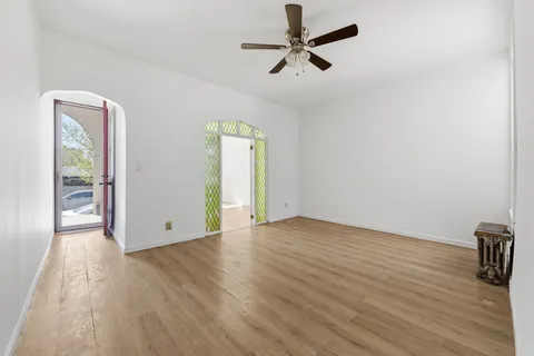 wooden floor in an empty room with a window