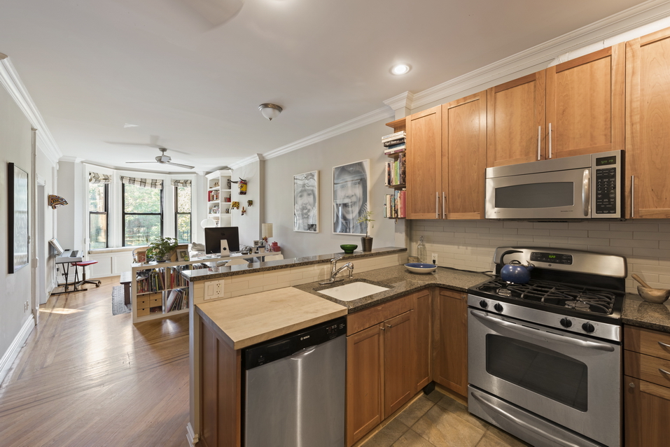 369 6th Avenue, Unit 2 Brooklyn, NY 11215 - Photo 3 of 9 a kitchen with stainless steel appliances a stove sink microwave cabinets and wooden floor