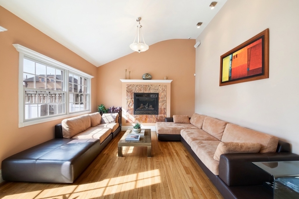 2310 East 66th Street Brooklyn, NY 11234 - Photo 11 of 24 a living room with furniture and a fireplace
