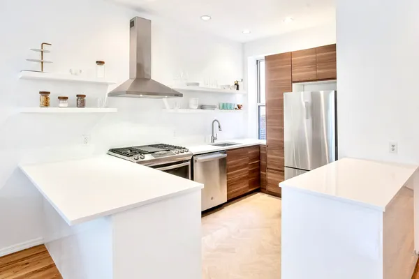 a kitchen with a stove a sink and a refrigerator