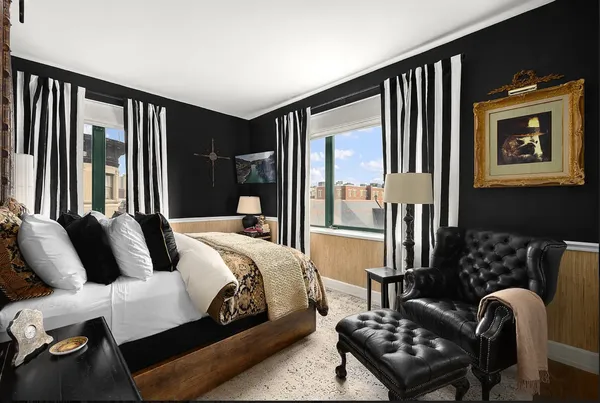 a bedroom with furniture and a window