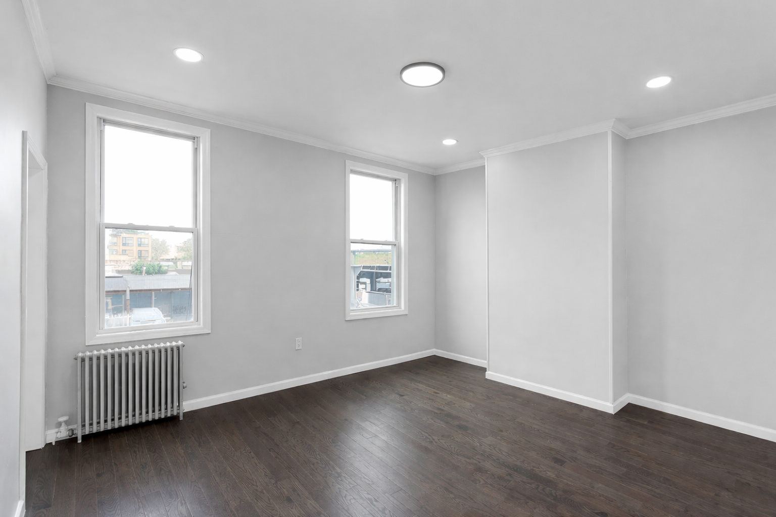 131 20th Street, Unit MULTI Brooklyn, NY 11232 - Photo 3 of 16 an empty room with wooden floor and windows