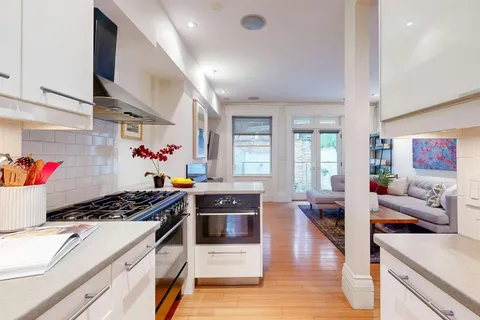 a kitchen with stainless steel appliances a stove a sink and cabinets
