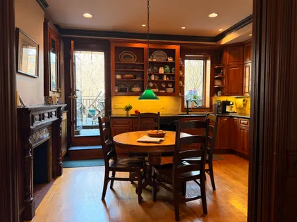a kitchen with a stove a sink and a dining table