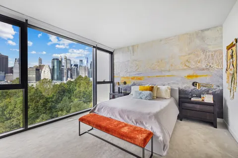 a living room with furniture and a floor to ceiling window