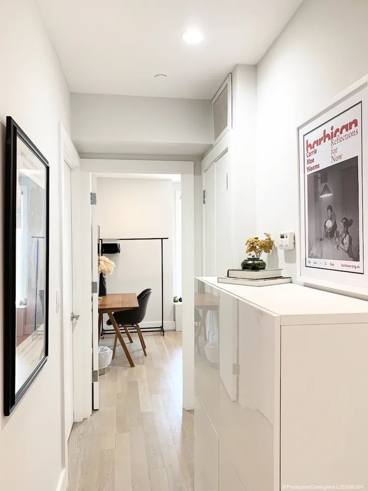 a living room with furniture and a painting on the wall