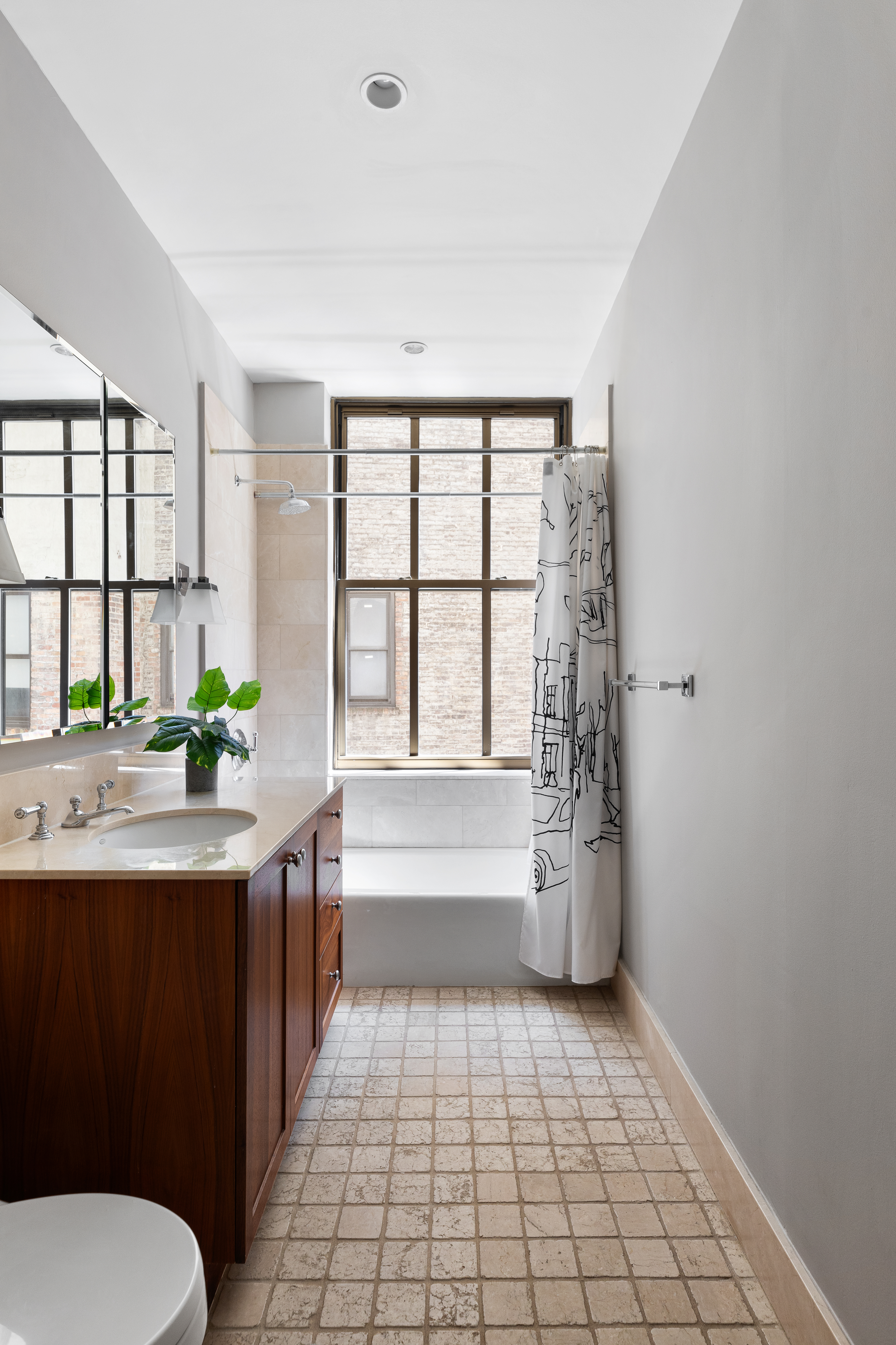 130 West 30th Street, Unit 3B Manhattan, NY 10001 - Photo 13 of 15 a bathroom with a granite countertop sink a large mirror and a bathtub