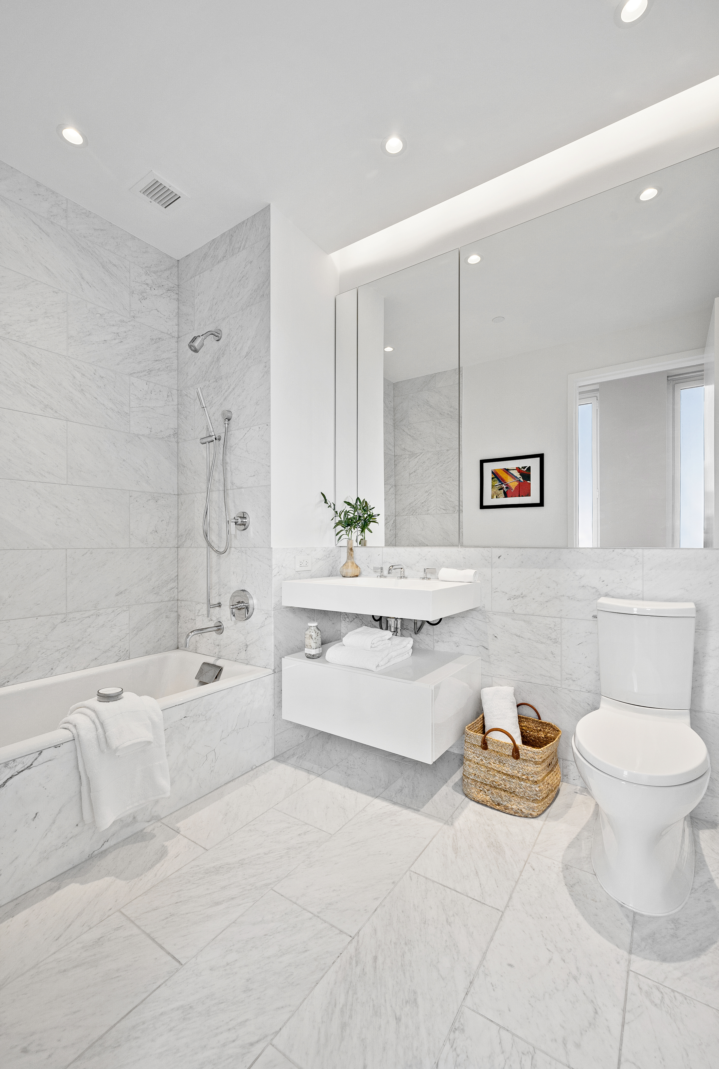 15 West 61st Street, Unit PH1C Manhattan, NY 10023 - Photo 22 of 26 a bathroom with a granite countertop sink mirror vanity bathtub and toilet