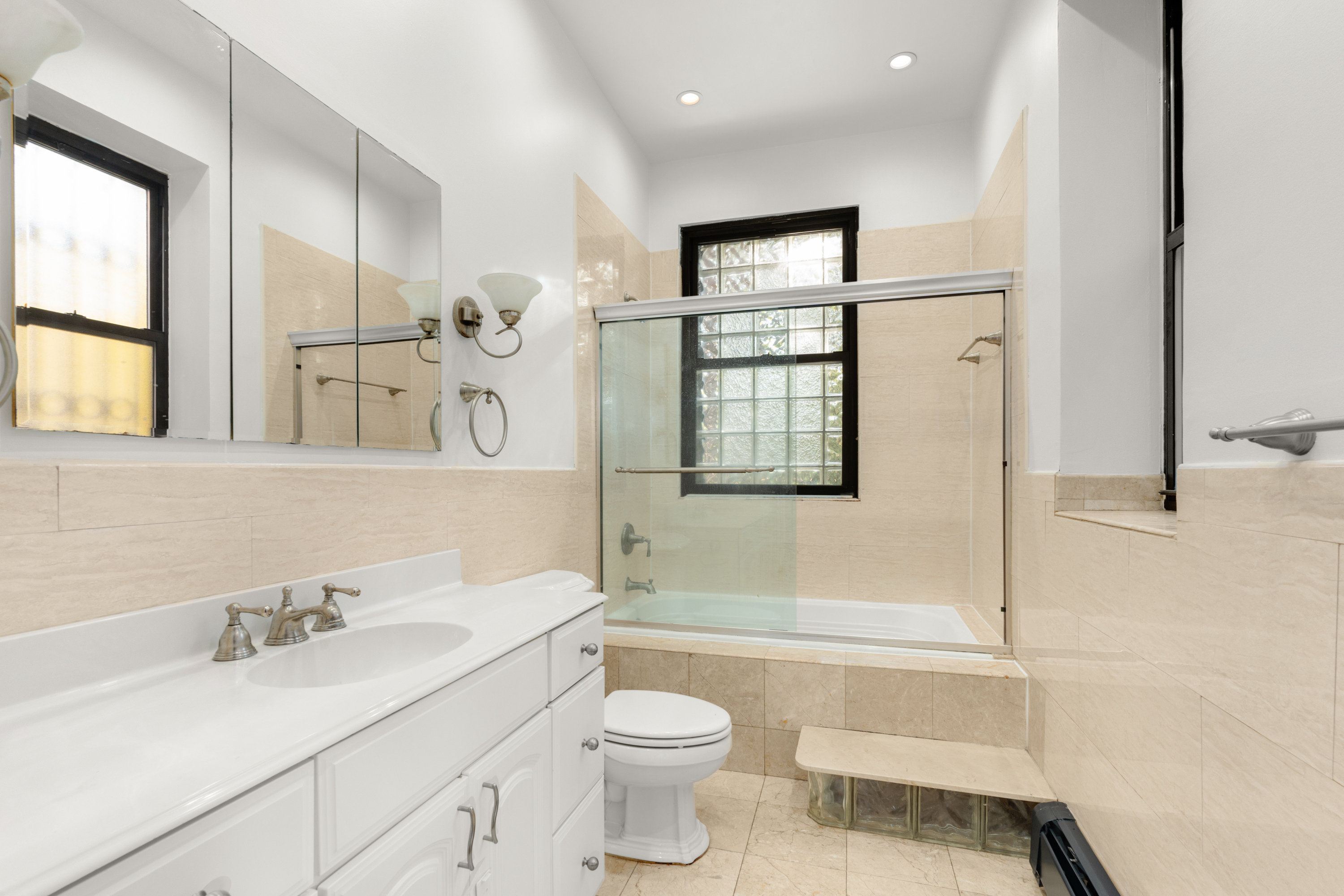 688 Saint Marks Avenue, Unit GARDEN Brooklyn, NY 11216 - Photo 11 of 13 a bathroom with a sink a toilet and shower