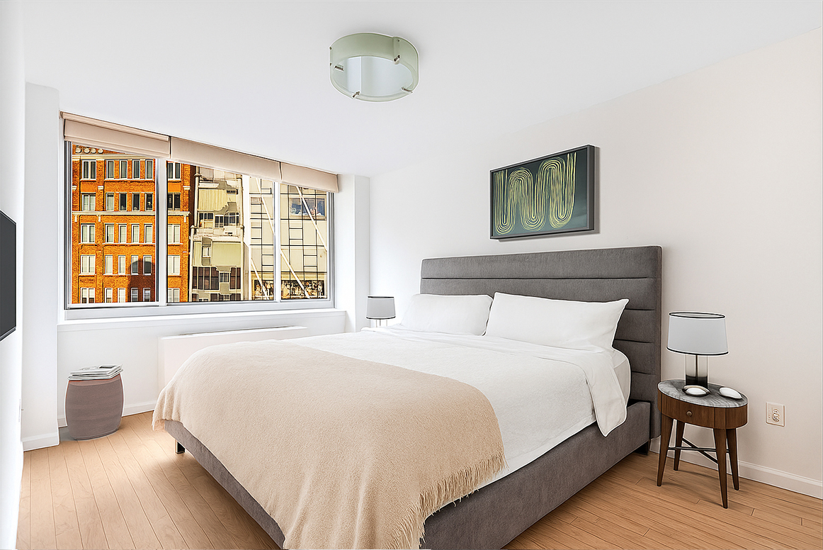 520 West 23rd Street, Unit 9D Manhattan, NY 10011 - Photo 4 of 10 a bedroom with a bed and a large window