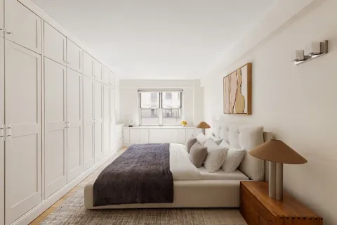 a bedroom with bed and a window