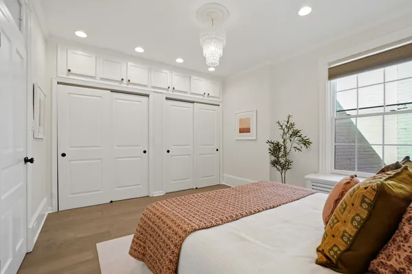 a spacious bedroom with a bed and a window