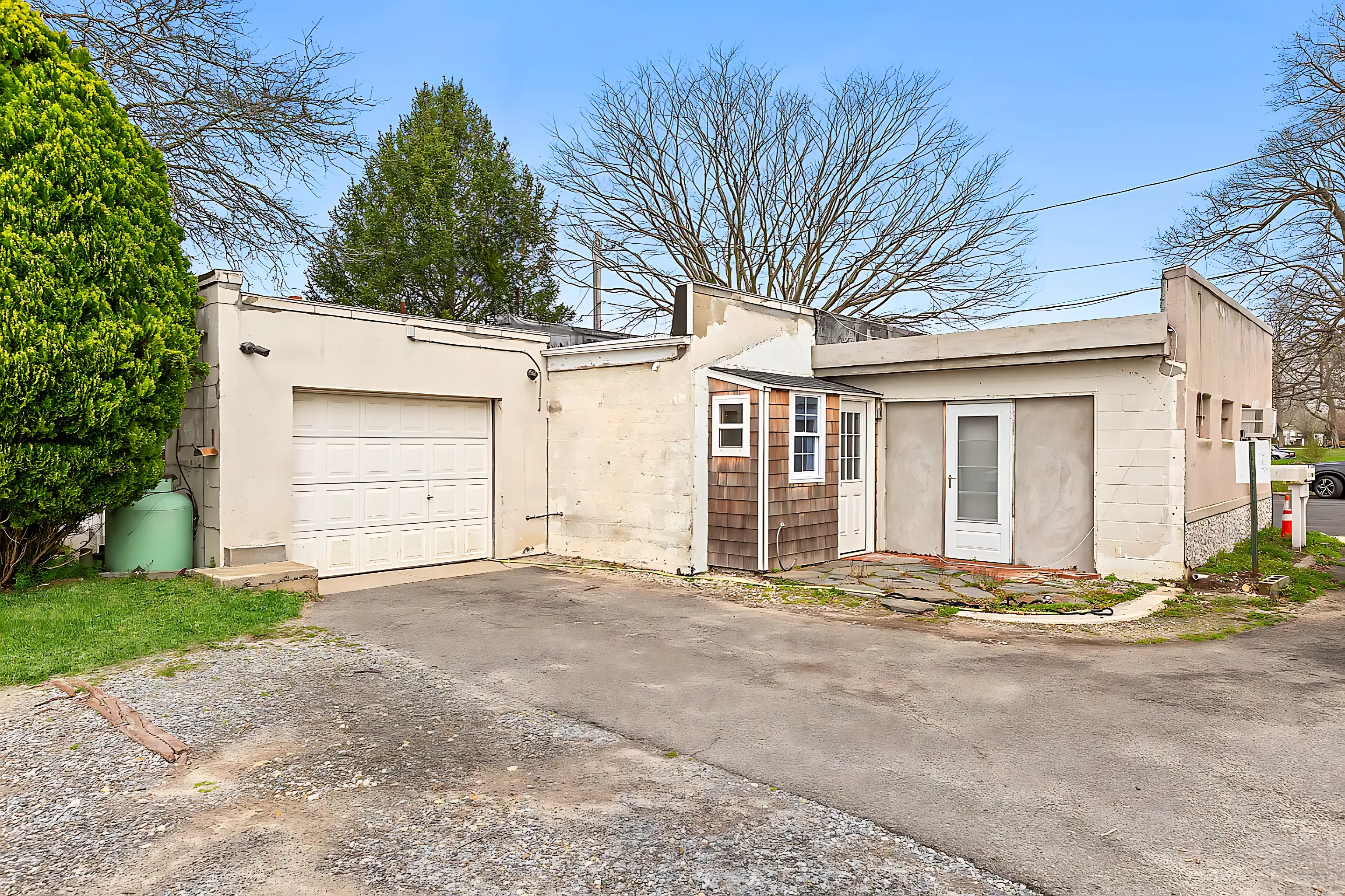 59 Maple Street Southampton, NY 11968 - Photo 5 of 6 a front view of a house with a yard and garage