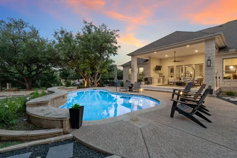 a view of a swimming pool with chairs
