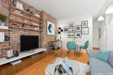 a living room with furniture flat screen tv and a fireplace