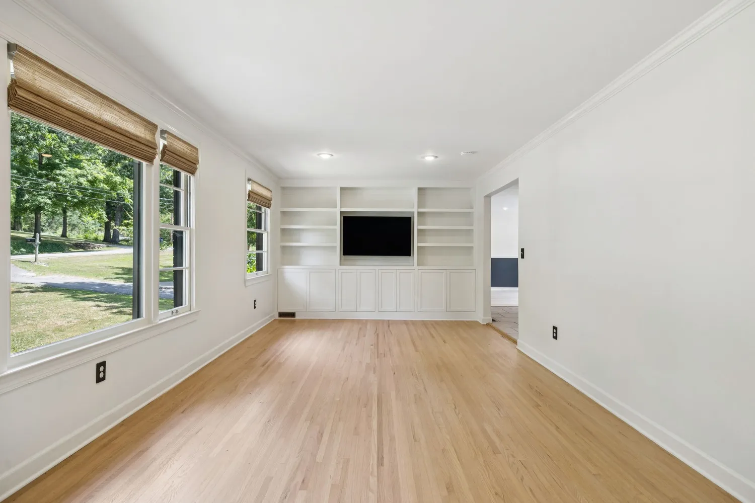 a view of a livingroom with wooden floor and window