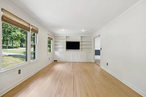 a view of a livingroom with wooden floor and window