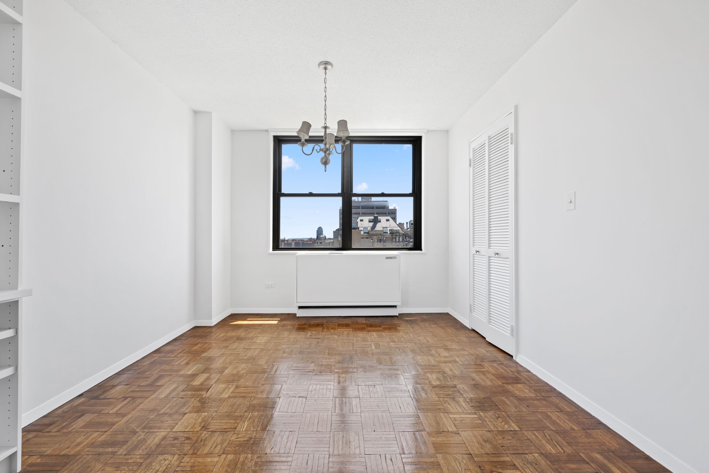 201 East 17th Street, Unit 15H Manhattan, NY 10003 - Photo 13 of 24 a view of an empty room with a window