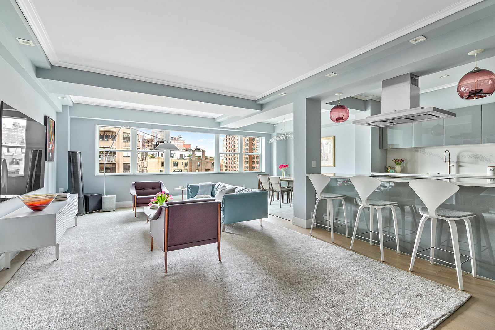 165 East 72nd Street, Unit 17L Manhattan, NY 10021 - Photo 2 of 12 a living room with lots of furniture and a large window