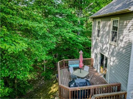 a view of balcony with deck and outdoor seating