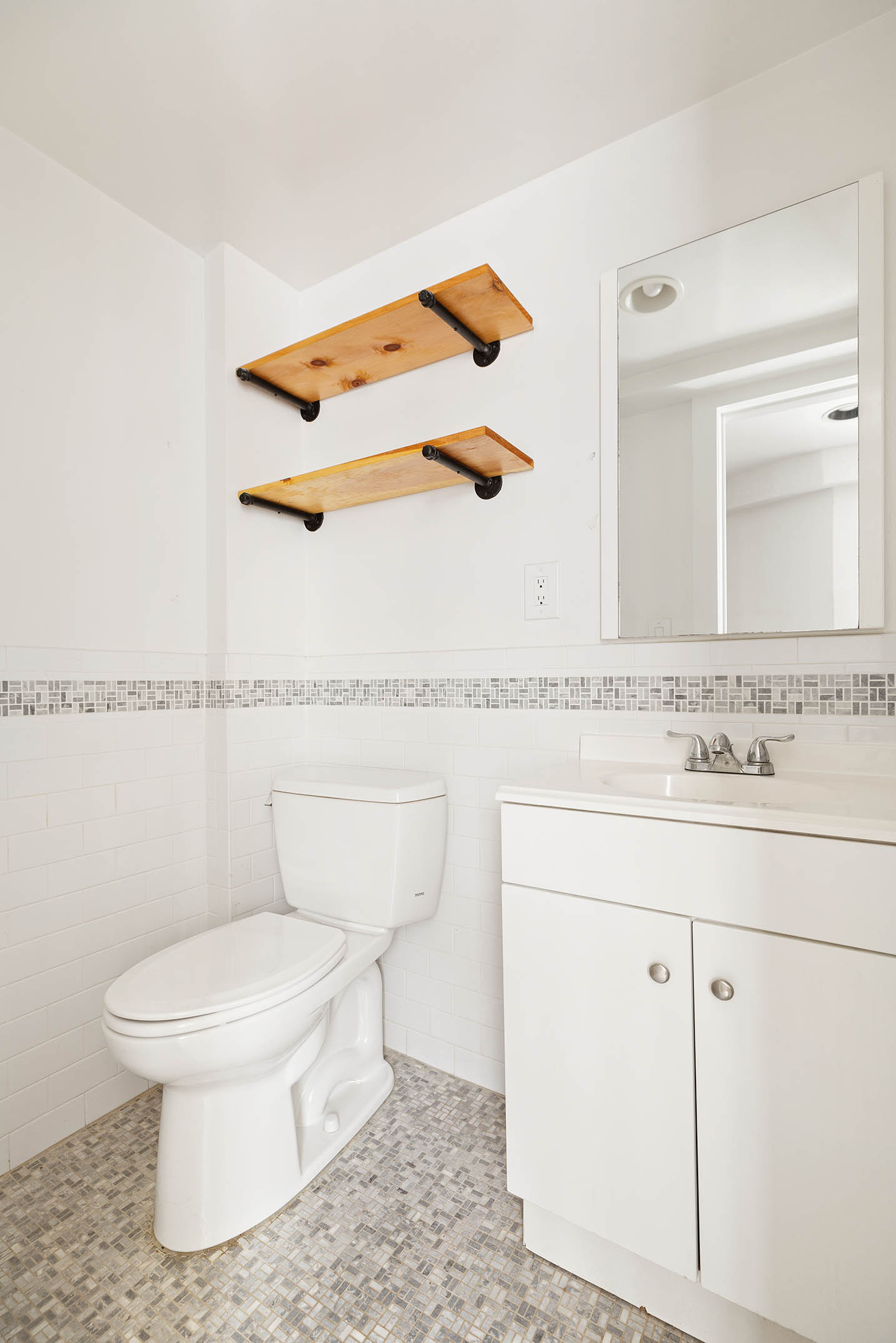 2116 Dorchester Road, Unit 1I Brooklyn, NY 11226 - Photo 11 of 15 a white toilet sitting next to a bathroom sink