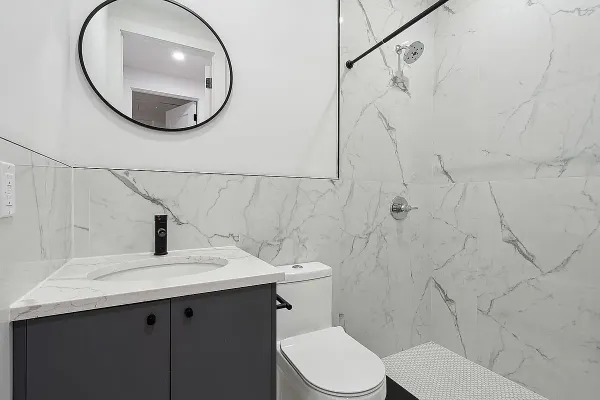 a bathroom with a sink mirror and toilet