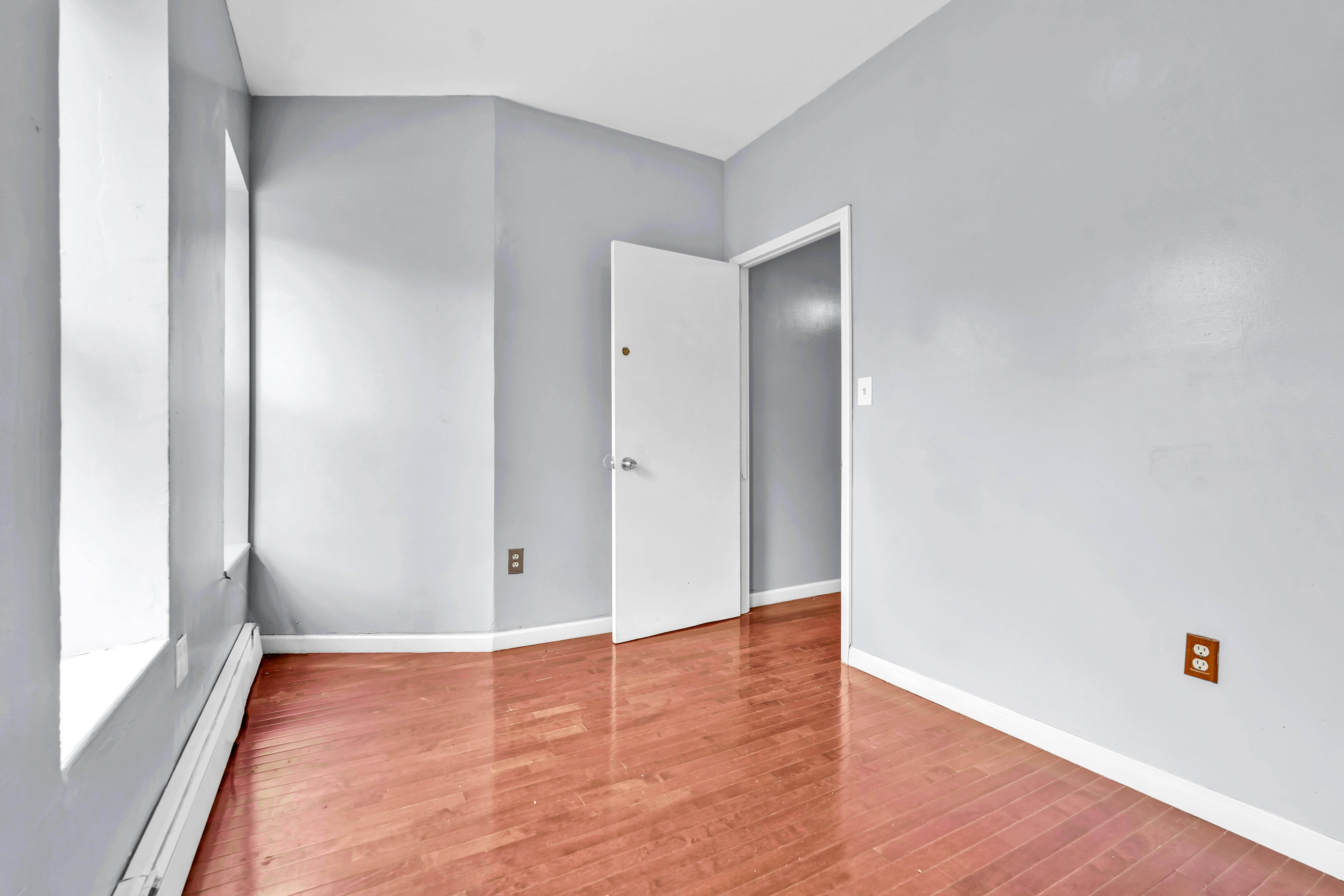 1633 St Johns Place, Unit 3 Brooklyn, NY 11233 - Photo 4 of 29 a view of an empty room with wooden floor and a window
