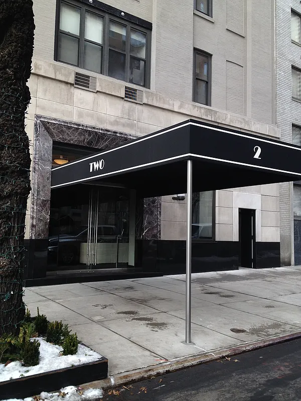 2 East End Avenue, Unit PHG Manhattan, NY 10075 - Photo 14 of 15 a kitchen with stainless steel appliances kitchen island granite countertop a stove