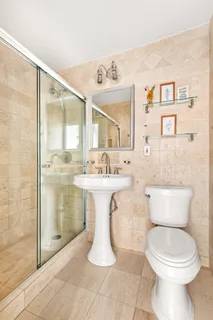 a bathroom with a sink toilet and shower