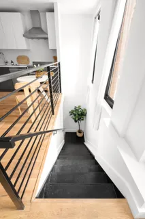 a view of a living room with furniture and a potted plant