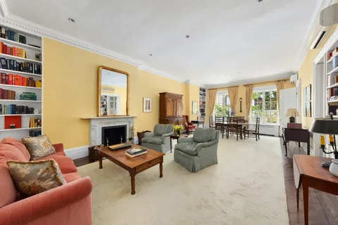 a living room with furniture a fireplace and a large window