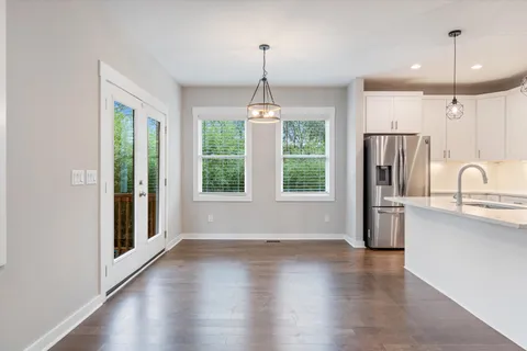 a view of a kitchen with a stove wooden floor and a window