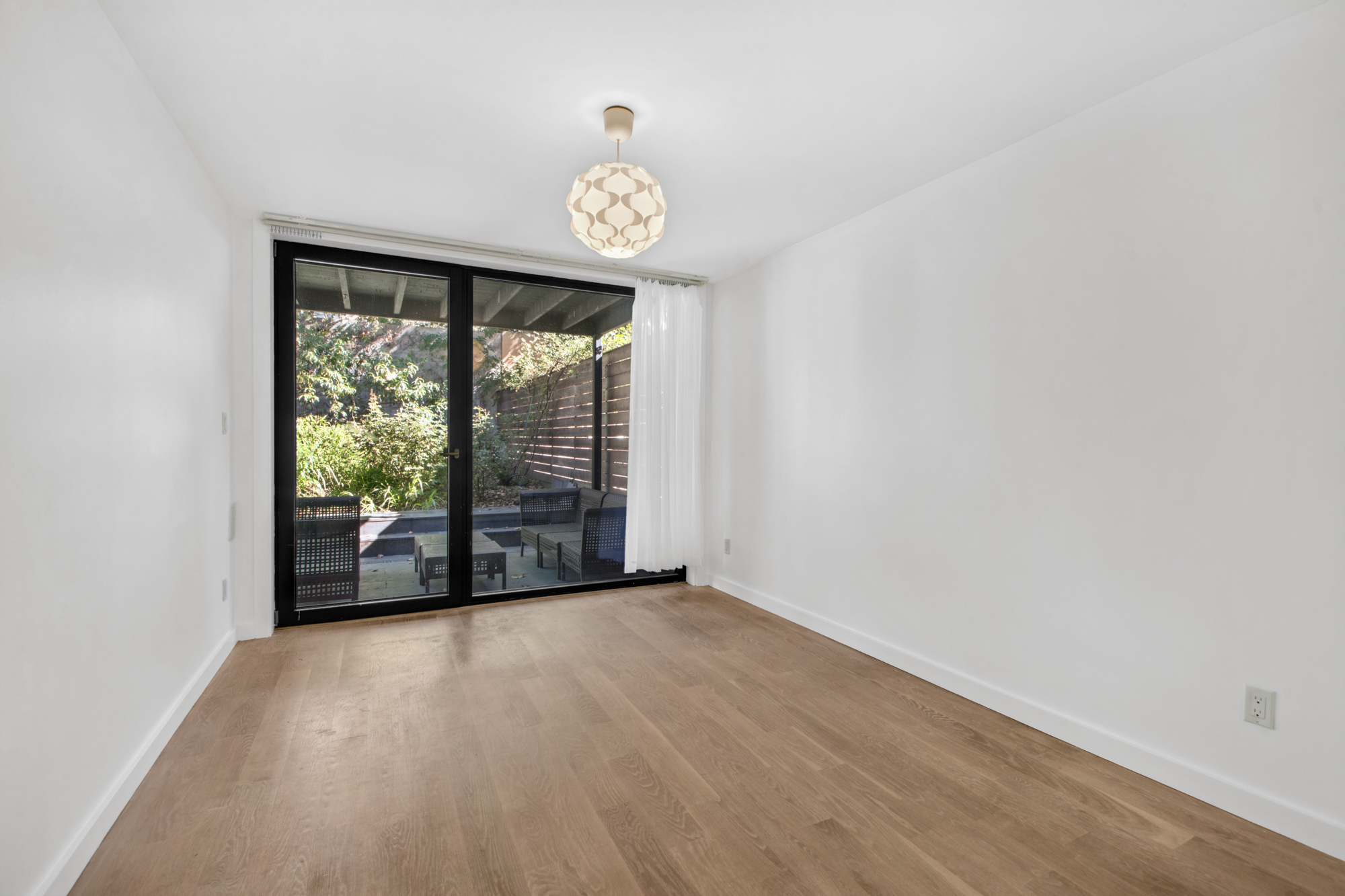435 Putnam Avenue, Unit GARDEN Brooklyn, NY 11221 - Photo 6 of 11 wooden floor in an empty room with a window