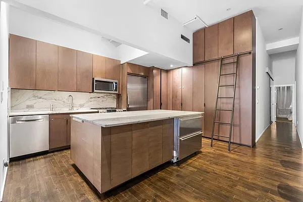 a kitchen with stainless steel appliances granite countertop a stove a sink and a refrigerator