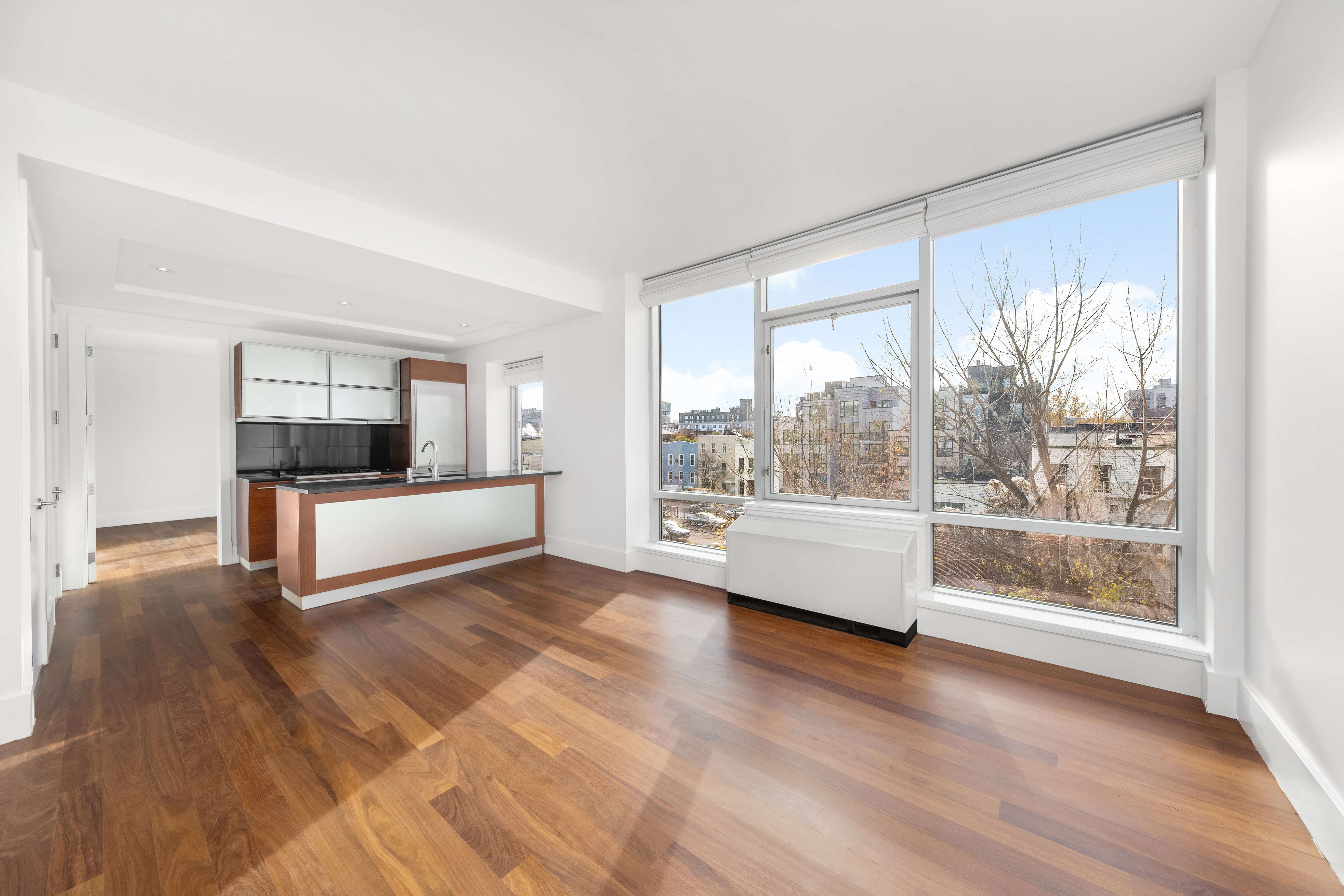 30 Bayard Street, Unit 4F Brooklyn, NY 11211 - Photo 2 of 12 a living room with a large window and a wooden floor