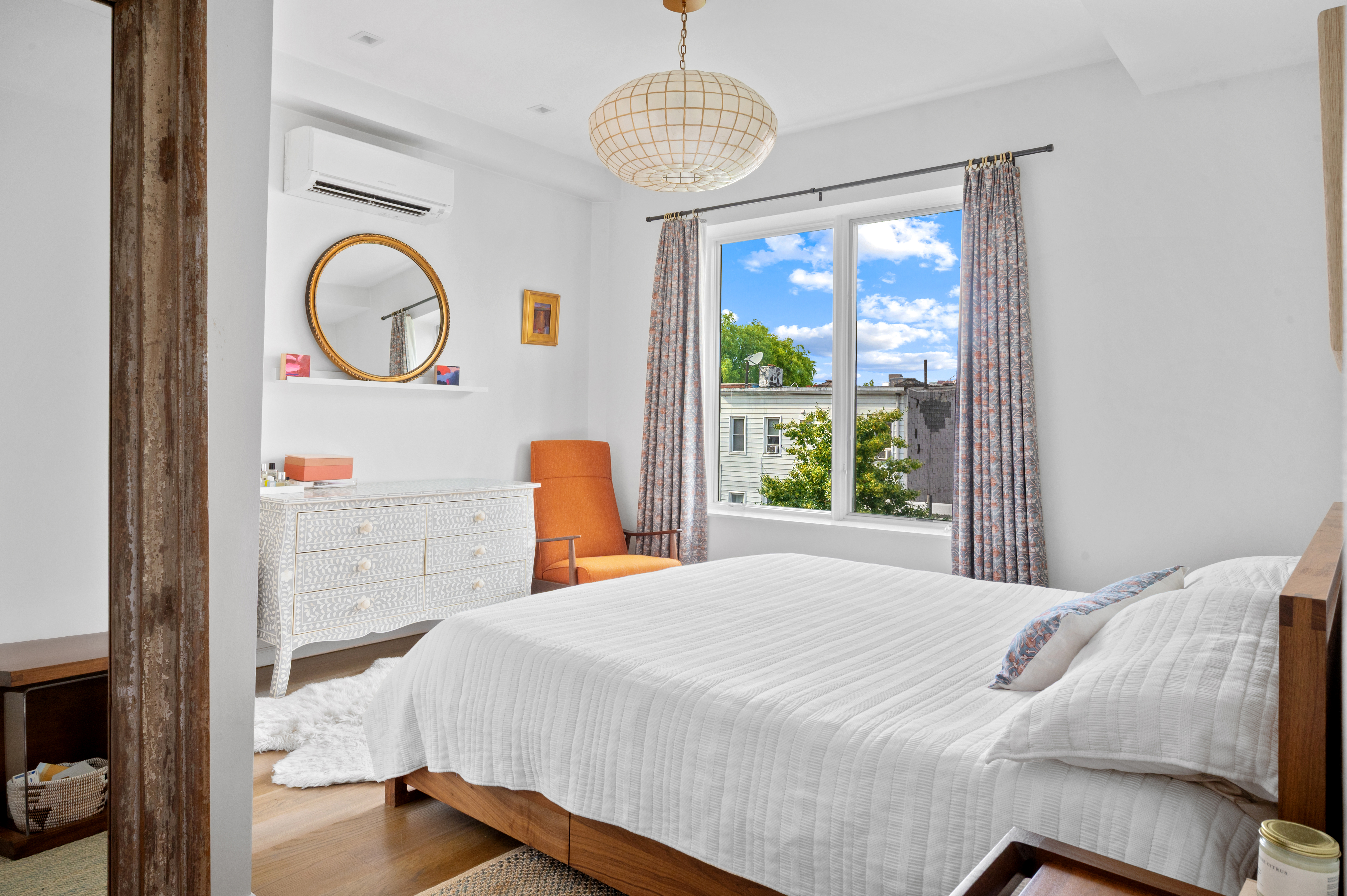 5-41 47th Road, Unit 2B Queens, NY 11101 - Photo 4 of 10 a bedroom with a bed and a large window